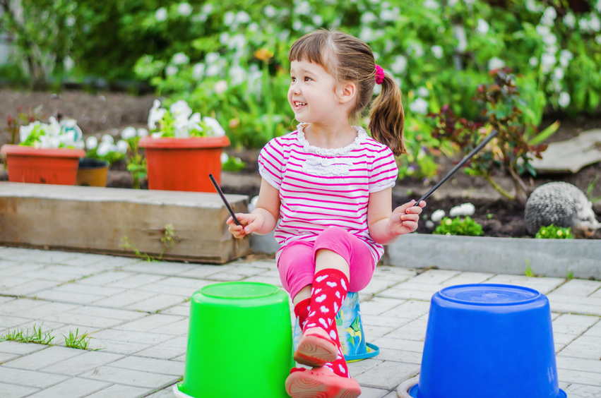 child with green and blue buckets
