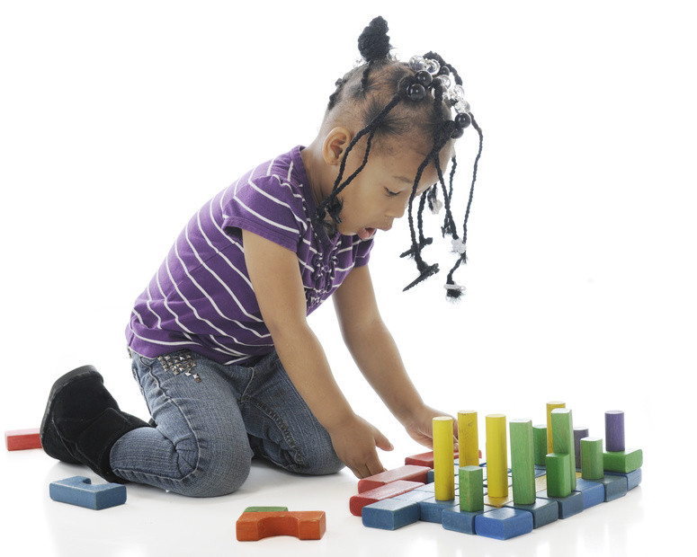 preschool child playing with math toys